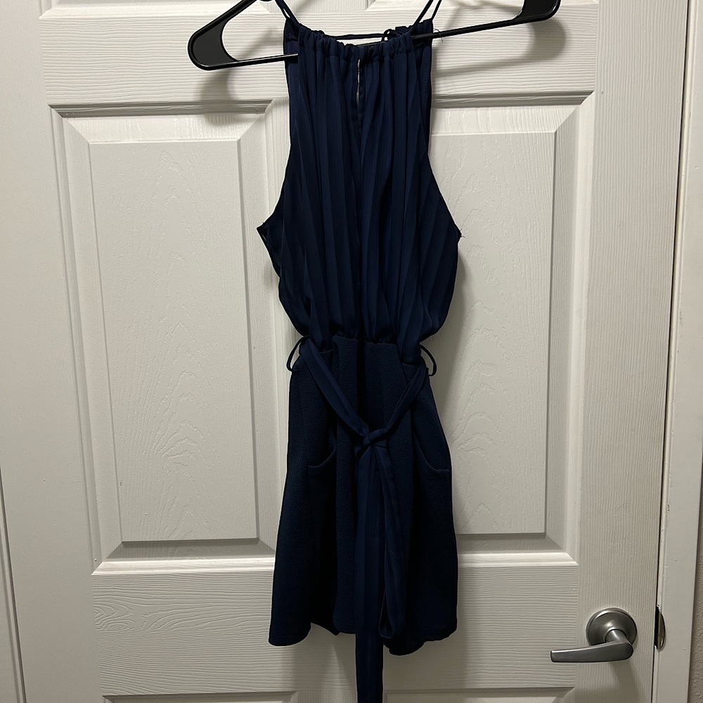 Blue sleeveless romper with pockets. Size large.